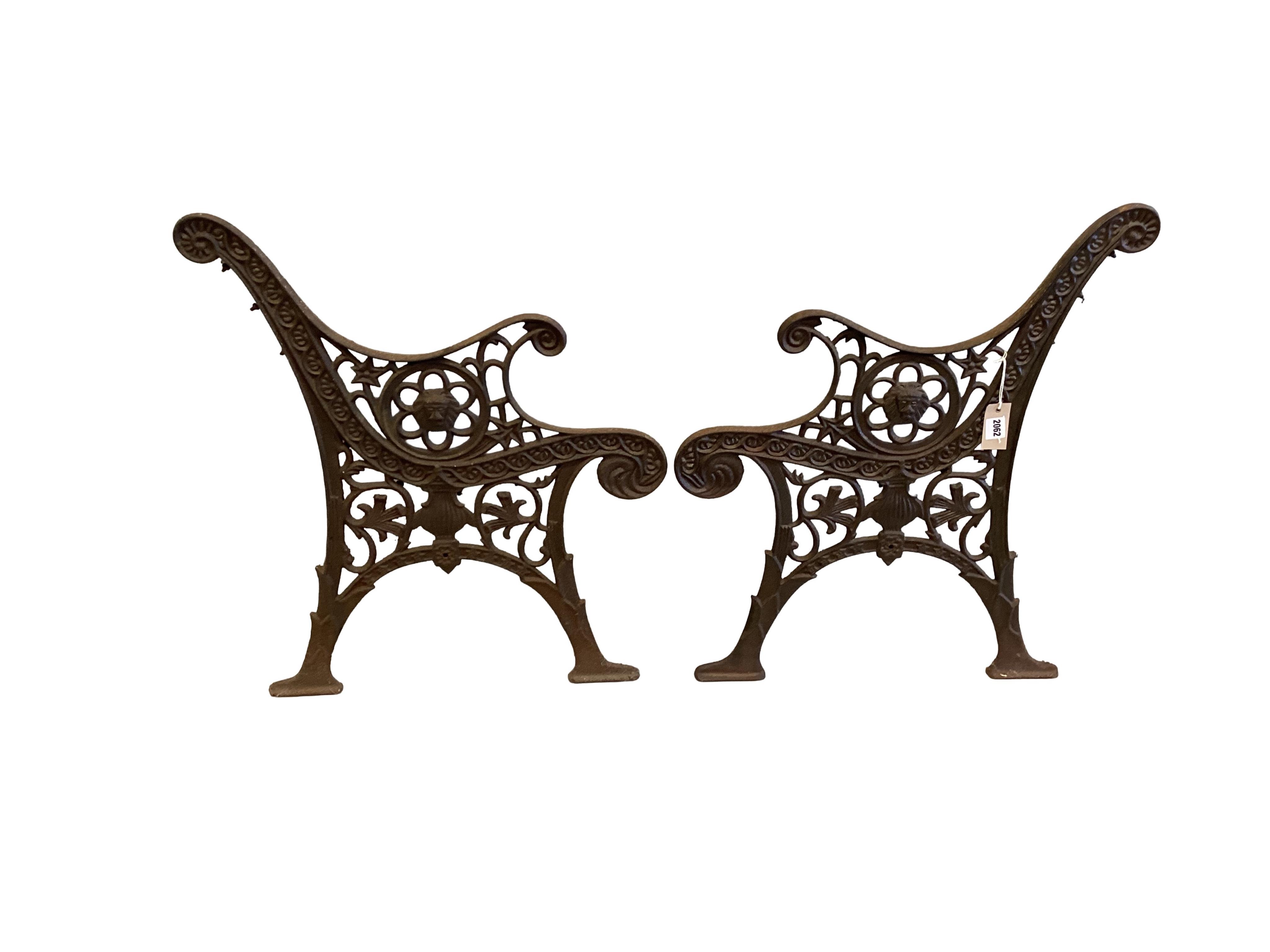 A pair of cast iron bench ends, each width 60cm, height 74cm